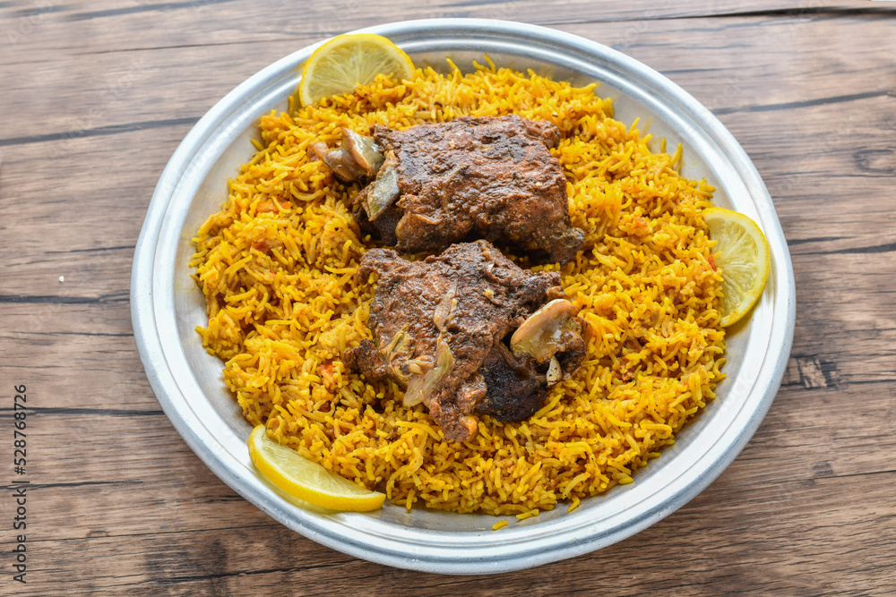 Arabian Kabsa meat rice with lemon slice served in dish top view of middle east food