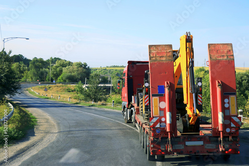 truck tractor rides on the road in summer