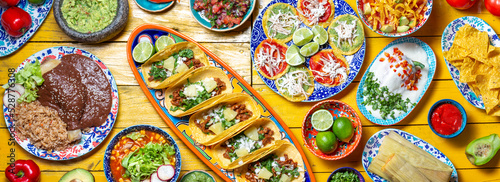 Mexican festive food for independence day independencia - chiles en nogada, tacos al pastor, chalupas pozole, tamales, chicken with mole poblano sauce. Yellow background. photo