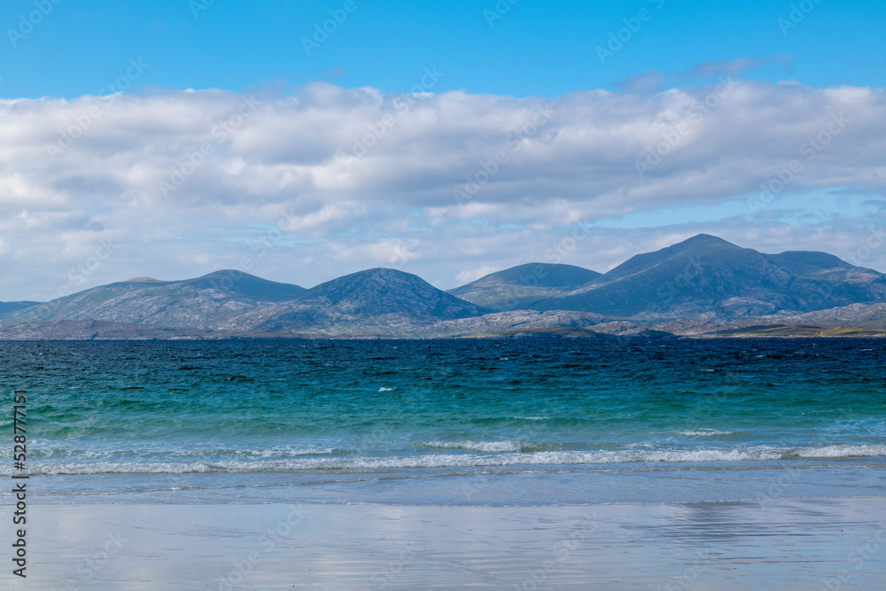 16 August 2022. Isle of Harris, Highlands and Islands, Scotland. This is a beach and the mountains on the Isle of Harris on an August sunny afternoon.
