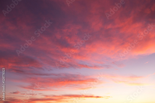 Dramatic soft sunrise, sunset pink violet orange sky with clouds background texture