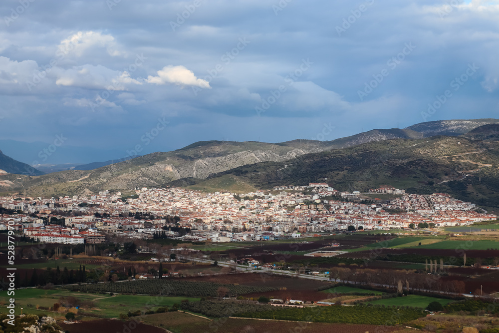 Cityscape - Landscape of Selcuk city near Ephesus enlightened by sun with mountains in the distance