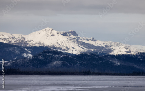 View of a frozen Yellowstone Lake with snow covered mountains in American Landscape. Yellowstone National Park. United States. Nature Background. © edb3_16