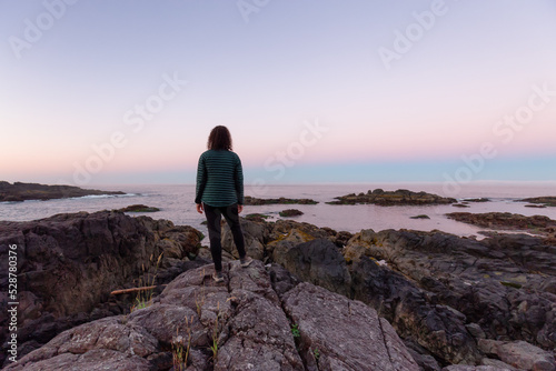 Adventurous Women Standing and Looking out to Ocean in Canadian Nature at Sunrise. Ancient Cedars Loop Trail. Ucluelet  British Columbia  Canada. Adventure Travel.