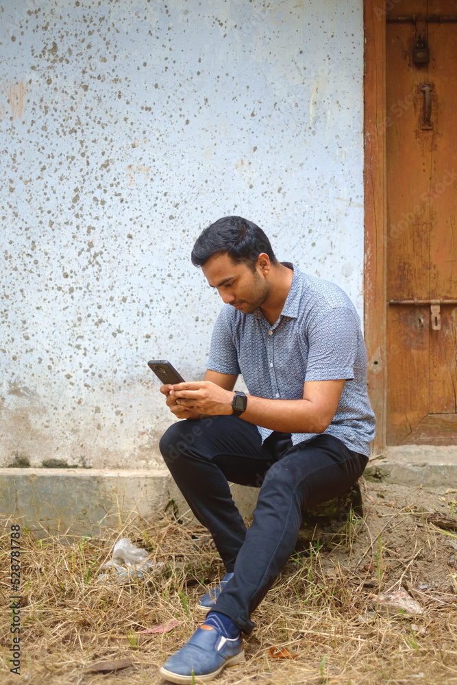 man reading a book as a pdf in a mobile phone man reading a book as a pdf in a mobile phone