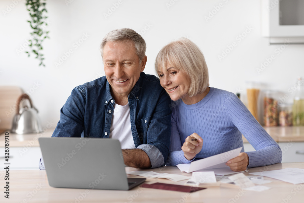 Happy pensioners sittting in front of computer, reading emails Happy pensioners sittting in front of computer, reading emails