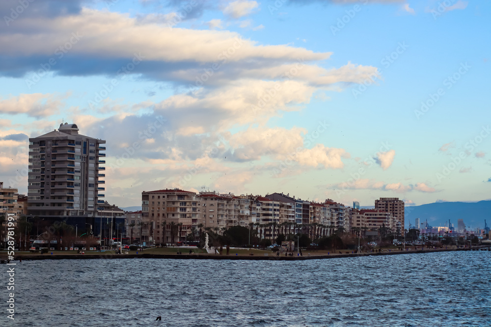 Fototapeta premium Mountains and the Aegean Sea on the coast of Izmir with copy space and appartment buildings