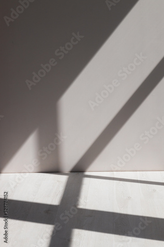 Stimulate scene of white empty room with sun light cast shadow on the laminate wood wall