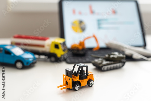 a set of toy vehicles and a tablet
