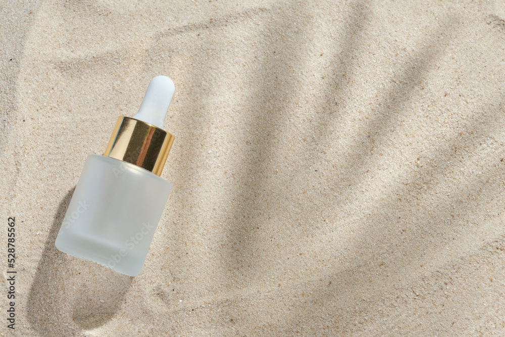 face serum of glass bottle with a pipette on a natural background with sand. Essential oil for moisturizing body skin. mockup of beauty fashion cosmetic bottle dropper product with skincare concept. face serum of glass bottle with a pipette on a natural background with sand. Essential oil for moisturizing body skin. mockup of beauty fashion cosmetic bottle dropper product with skincare concept.