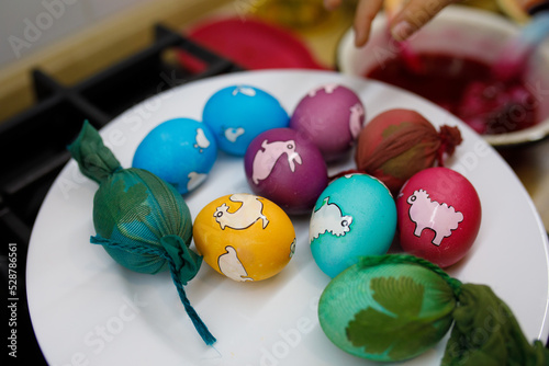 painted eggs with different colors on a plate photo