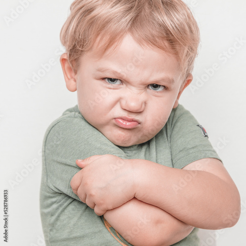 Angry boy looks into camera