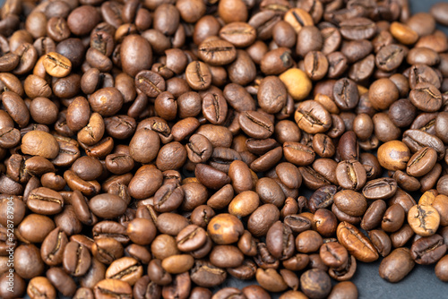 Fototapeta Naklejka Na Ścianę i Meble -  Top view of roasted coffee beans for background and texture. A pile of roasted and ground coffee beans can be used as a background and texture.