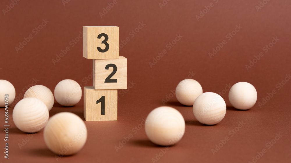 wooden cubes block with numbers 321, brown background wooden cubes block with numbers 321, brown background