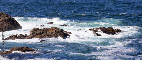 Rugged Rocks on a rocky shore on the West Coast of Pacific Ocean. Summer Morning Sky. Ucluelet, Vancouver Island, British Columbia, Canada. Nature Background