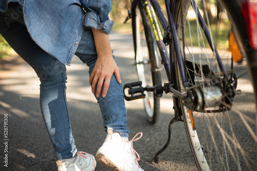 leg pain, cramp after cycling girl in jeans