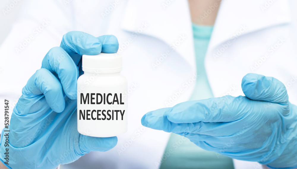Medical necessity text on the label of the can in the hands of a doctor close-up, medical concept Medical necessity text on the label of the can in the hands of a doctor close-up, medical concept