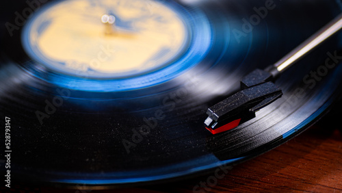 Photography Record with a blue hue on a turntable with needle