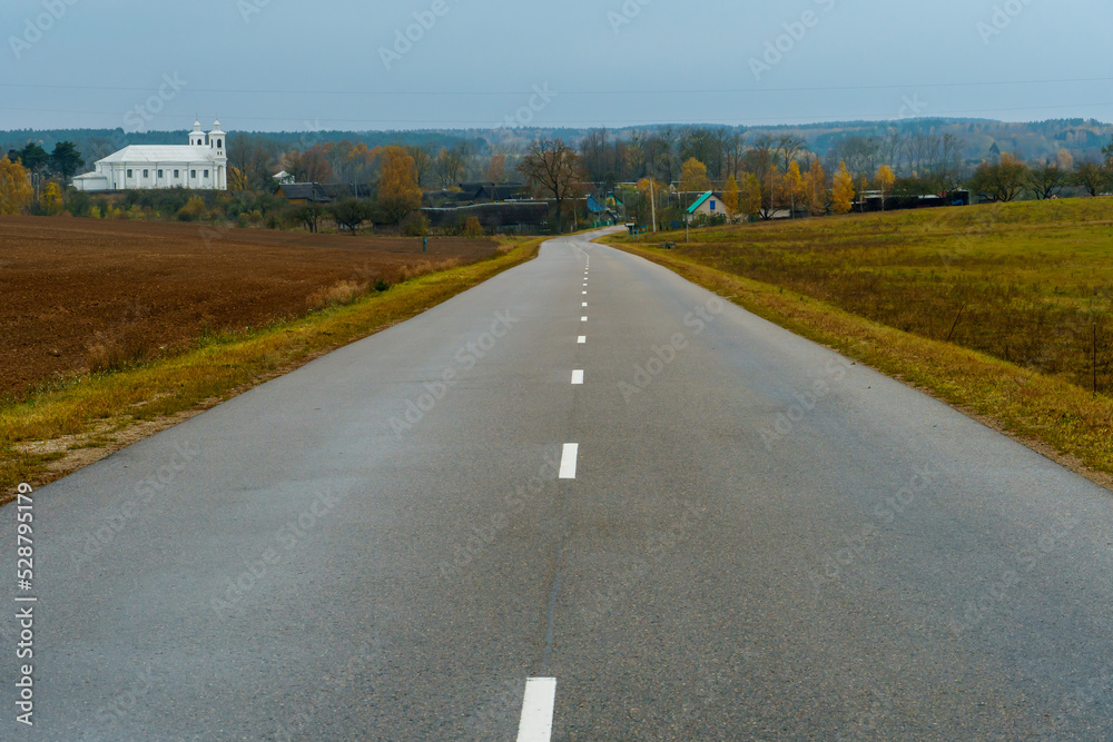 Obraz premium New modern asphalt in rural areas. High-quality conditions for business development in the field of cargo transportation and logistics.