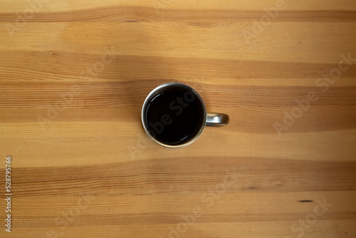 Cup of black coffee on wooden table for breakfast