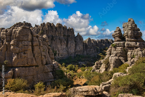 Panoramic view of the famous Torcal de Antequera, Malaga, Spain. Views of the rocky mountains on a sunny day with blue sky in the background and some white clouds.