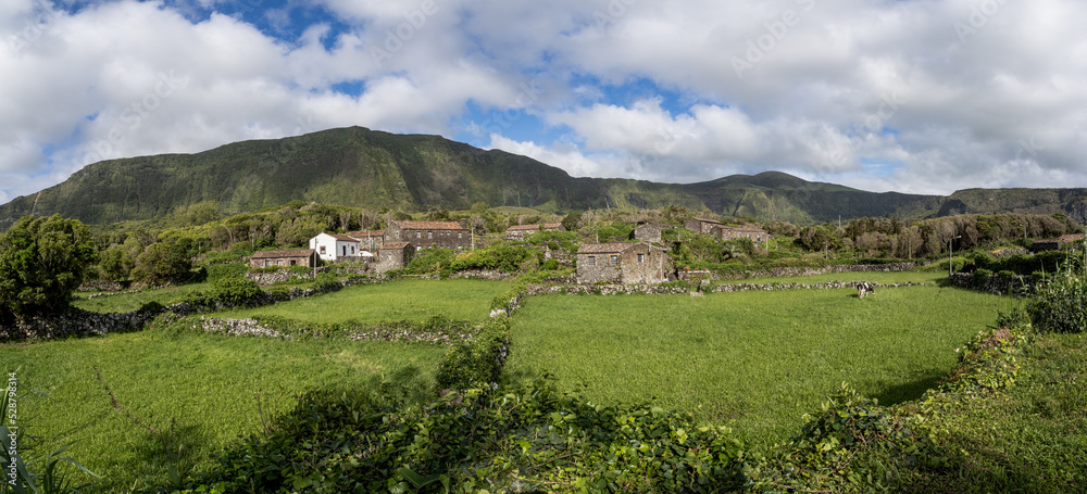 General view of the historic village of Cuada, now a tourist village, surrounded by cliffs and with green meadows in the foreground.
Flores Islands, Portugal.