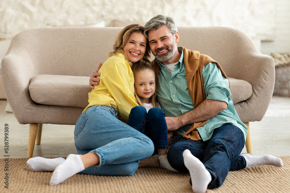 Happy Parents And Kid Daughter Hugging Posing At Home Happy Parents And Kid Daughter Hugging Posing At Home
