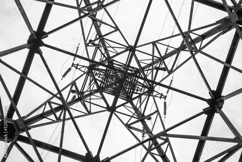 Bottom up view of electrical transmision high-voltage tower.