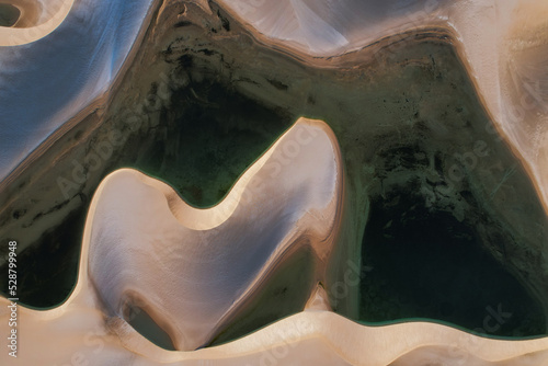Aerial view of a white desert with blue lakes at sunset in Brazil