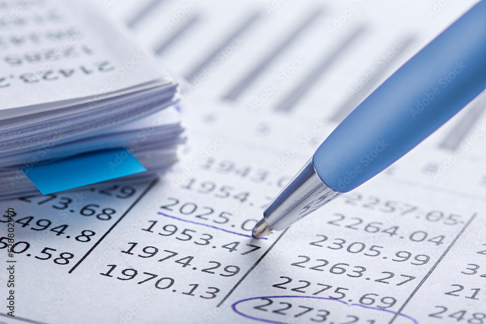 Accounting document with pen, money, coins and checking financial chart. Concept of banking, financial report and financial audit. Accounting document with pen, money, coins and checking financial chart. Concept of banking, financial report and financial audit.