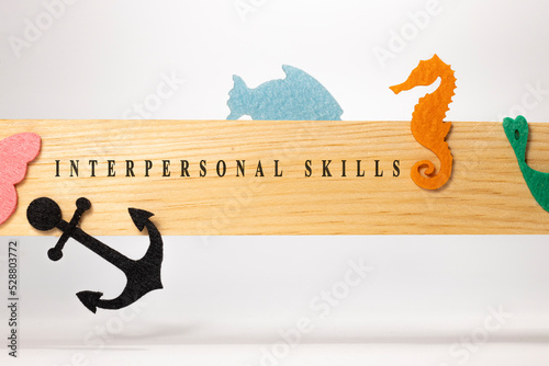 interpersonal skills written on a wooden patterned surface. Education and child psychology photo