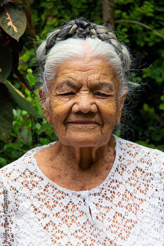 Mexican grandmother smiling with her eyes closed.