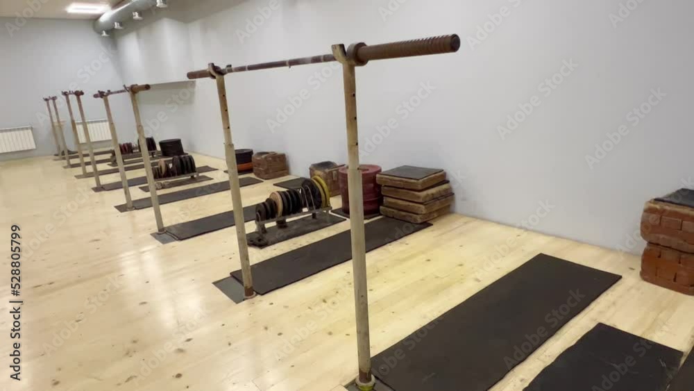 interior of a room. Premises for training weightlifters. Old simulators for pumping muscle mass. Fitness room. A gym with exercise machines. Squat deadlift with a barbell.