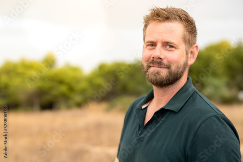 Close-up of a caucasian man smiling outside at the park