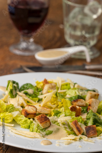caesar salad with a glass of wine
