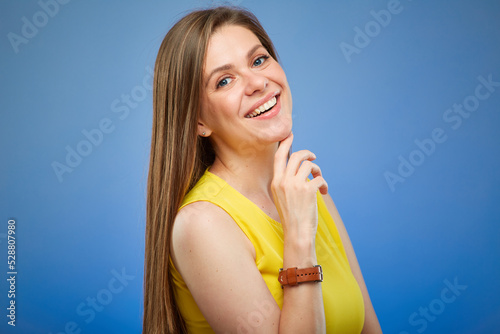 Woman smiling and . Isolated female portrait on blue background.