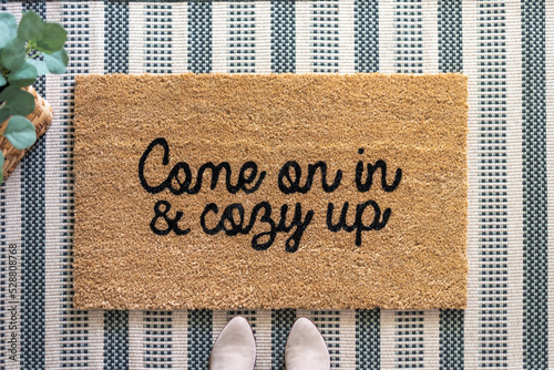 Top view of a stylish welcome mat that says Come on in and cozy up