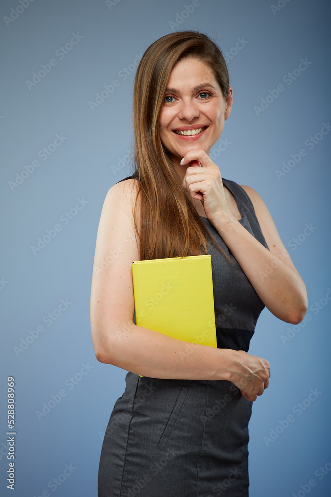 Smiling female teacher or business woman holding yellow book isolated portrait. Smiling female teacher or business woman holding yellow book isolated portrait.