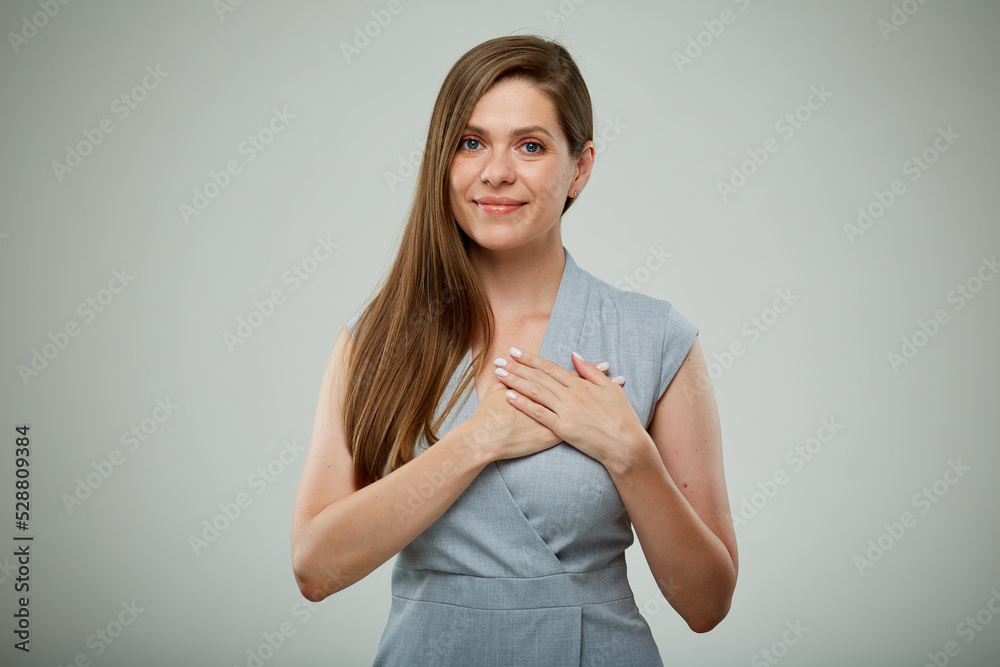 Happy young successful business woman holding hands on chest. isolated portrait. Happy young successful business woman holding hands on chest. isolated portrait.