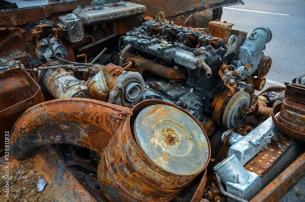 Close-up of burnt rusty engine in russian military vehicle after combat strike Close-up of burnt rusty engine in russian military vehicle after combat strike