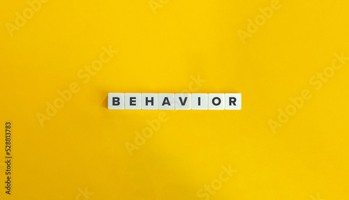 Behavior Word on Block Letter Tiles on Yellow Background. Minimal Aesthetics.