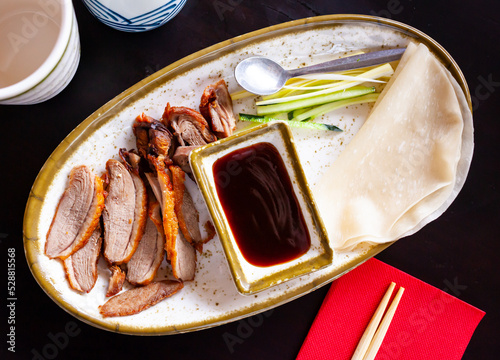 Traditional dish of Chinese cuisine is delicious Peking duck served with hoisin sauce photo
