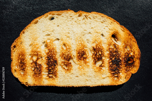 grilled, toasted sourdough bread on dark background