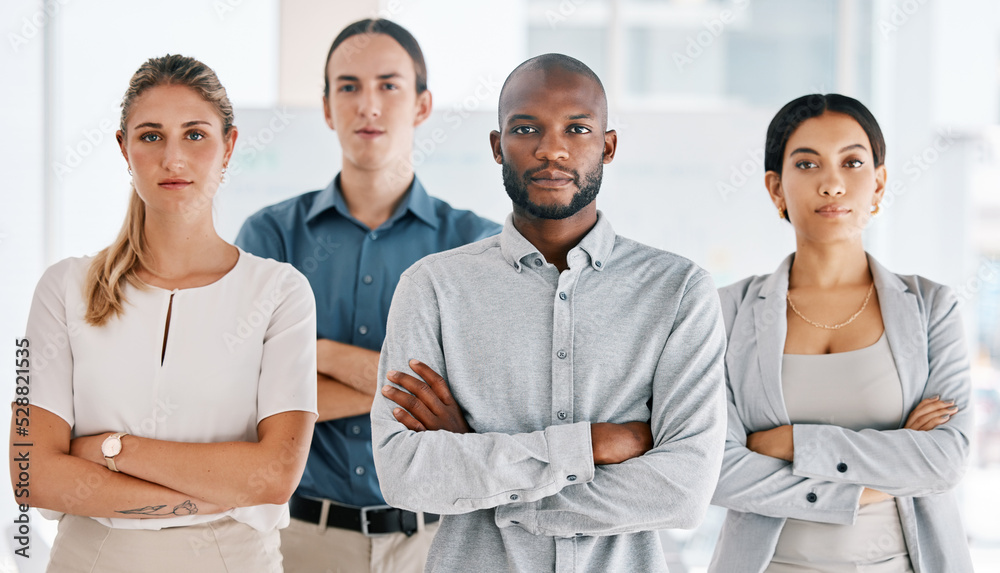 Motivation, arms crossed and serious with business people standing in corporate company building together. Innovation teamwork and goals with employees in conference, workshop or meeting