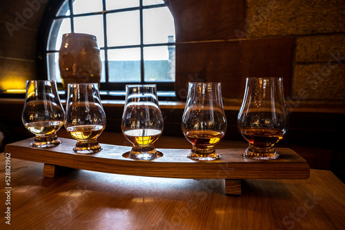 Obraz na płótnie Flight of single malt scotch whisky in glasses served in whiskey bar in Edinburg