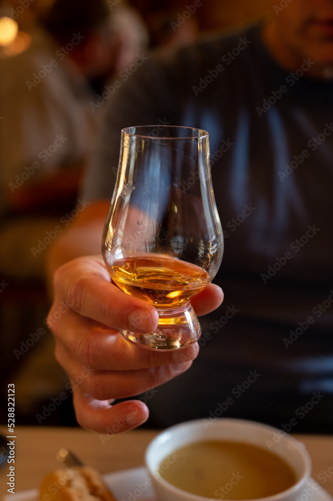 Tasting of single malt scotch whisky in whiskey bar in Edinburgh, UK