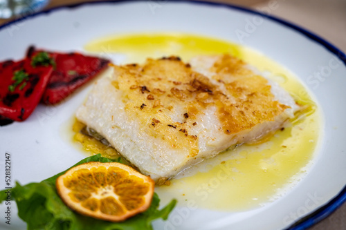 Grilled fillet of white sea bass served in fish restaurant in San Sebastian, Basque Country, Spain
