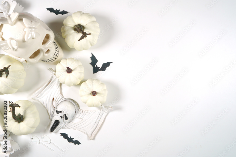 White Halloween framed border background. Styled with white skull and pumpkins with negative copy space. White Halloween framed border background. Styled with white skull and pumpkins with negative copy space.