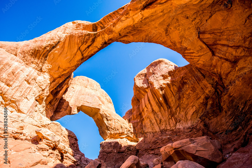 Double Arch against a sunny sky in Arches National Park of Utah