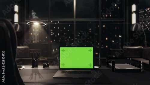Laptop Computer with Green Screen Chroma Key Display on top of Corporate Office Desk. Late Night. Mockup.